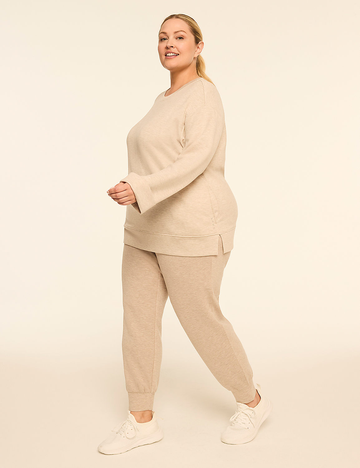 A woman in a beige loungewear set walks against a plain, light-colored background. Product Image 3