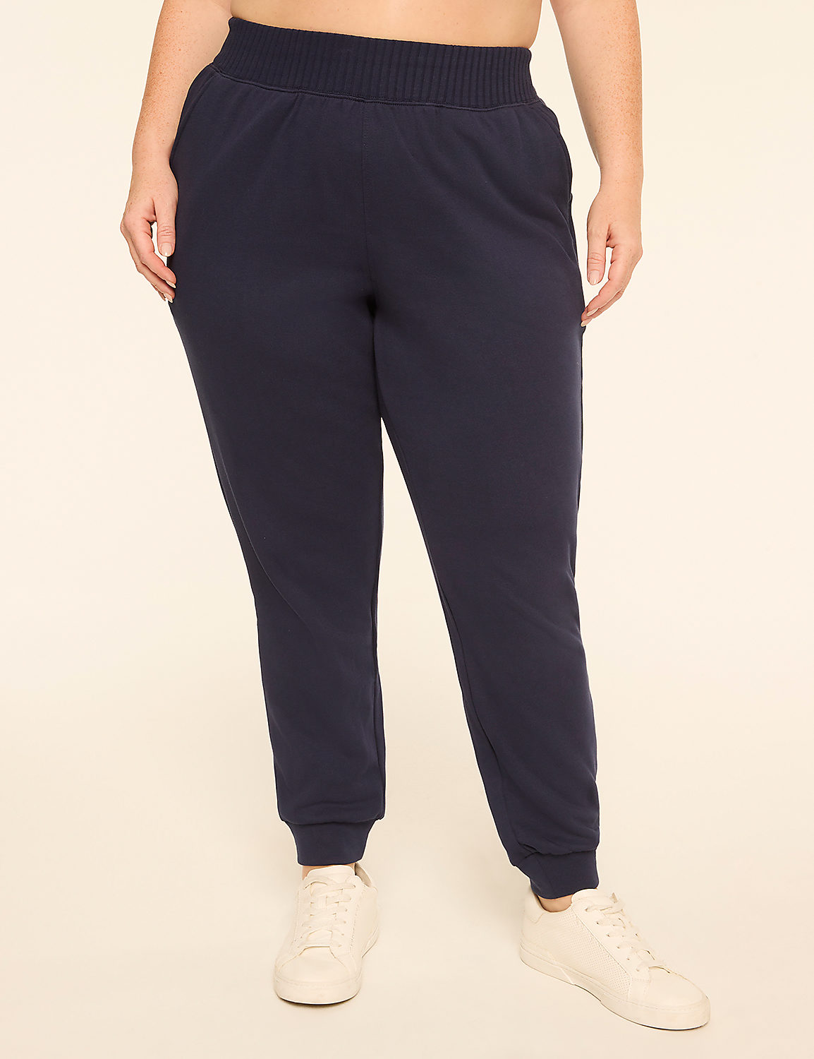 A person in navy blue sweatpants and white sneakers stands against a plain, light-colored background. Product Image 1