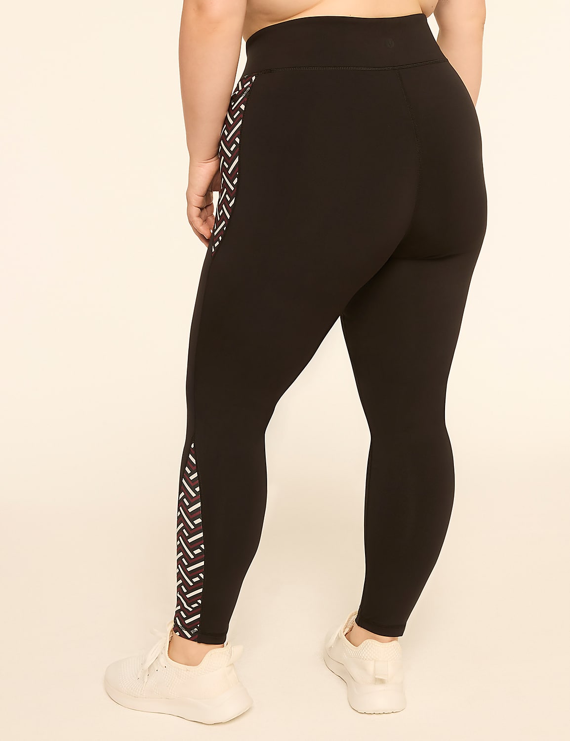 A person wearing black leggings with a geometric pattern on the side stands against a plain, light-colored background. Product Image 2