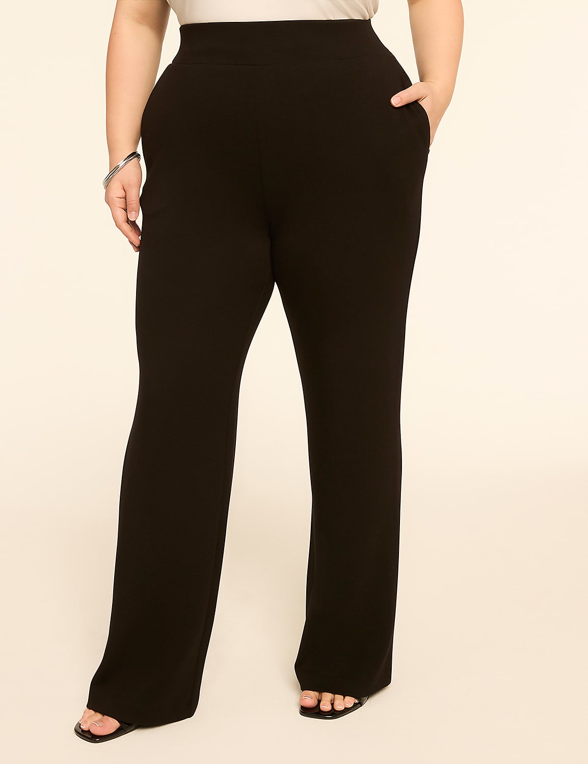 A person in black flared pants stands against a plain, light-colored background. Product Image 1