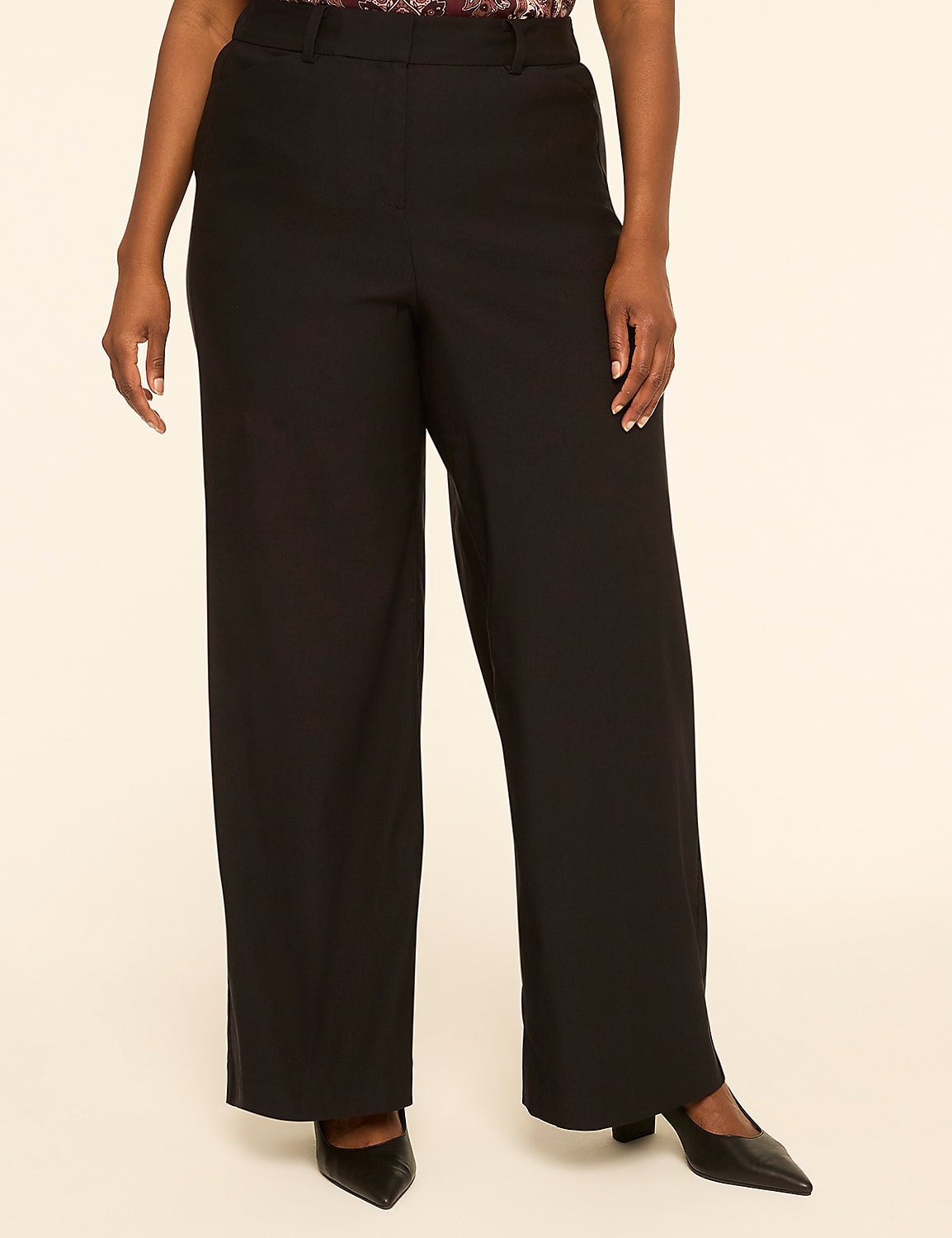 A person stands in black wide-leg pants and pointed-toe heels against a plain, light-colored background. Product Image 1