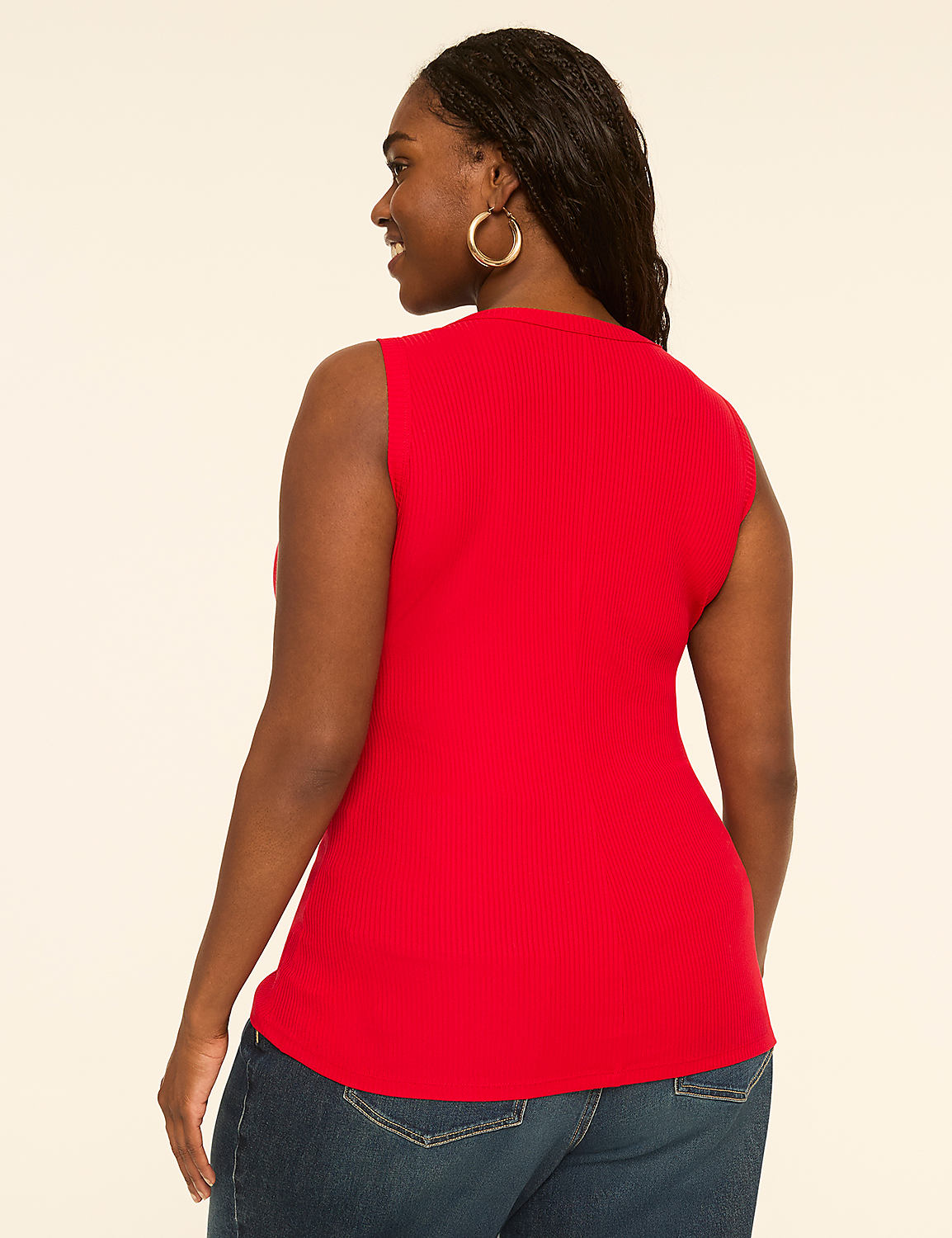 A woman in a red sleeveless top and blue jeans stands against a plain, light-colored background. Product Image 2