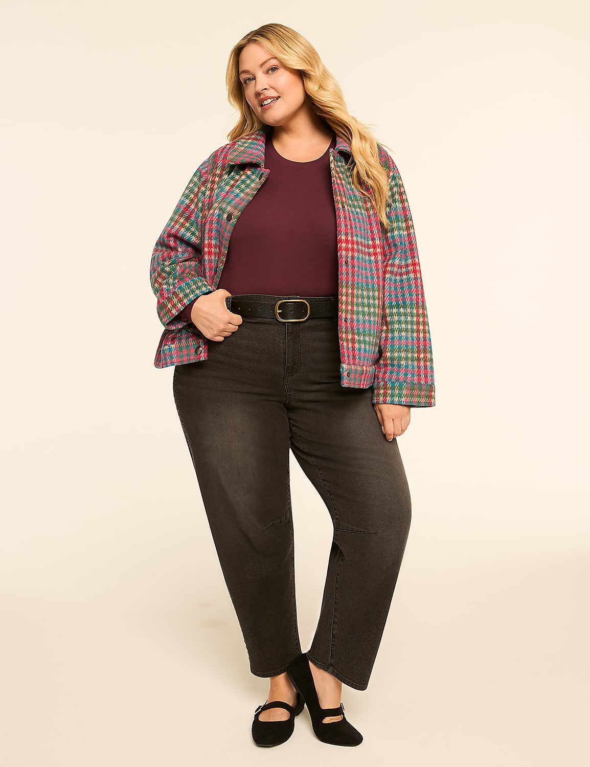 A woman in a plaid jacket and dark jeans stands against a plain, light-colored background. Product Image 3