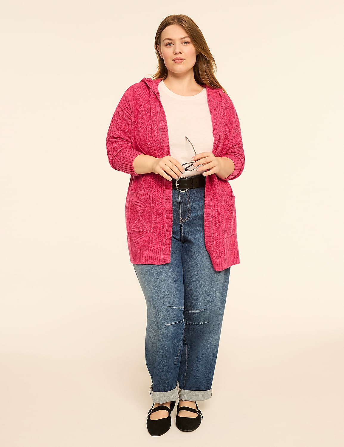 A woman in a pink hooded cardigan and jeans stands against a plain cream background. Product Image 3