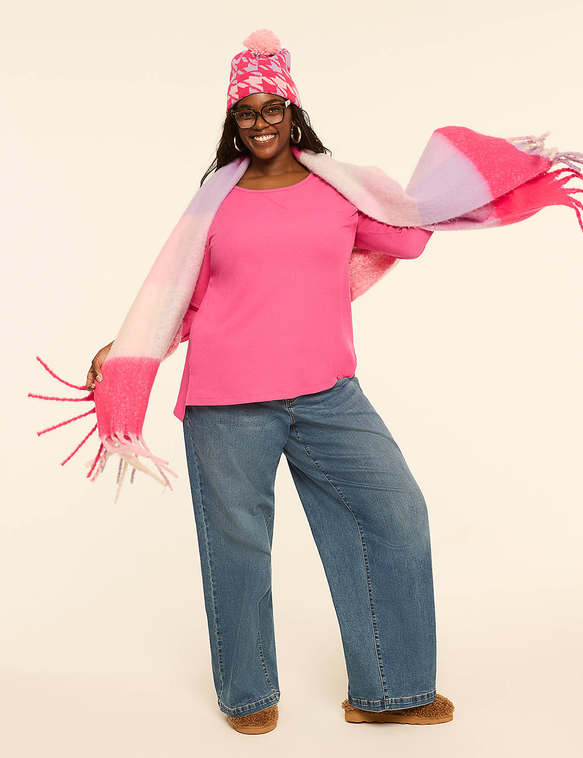 A woman in a pink beanie, scarf, and top, paired with wide-leg jeans, poses against a plain, light-colored background. Product Image 3