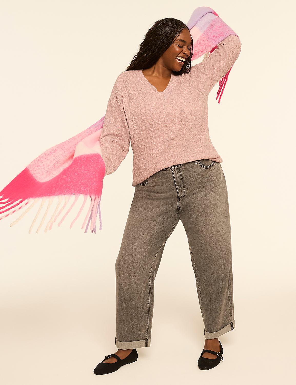 A woman in a pink sweater and gray jeans poses with a colorful scarf against a plain background. Product Image 3