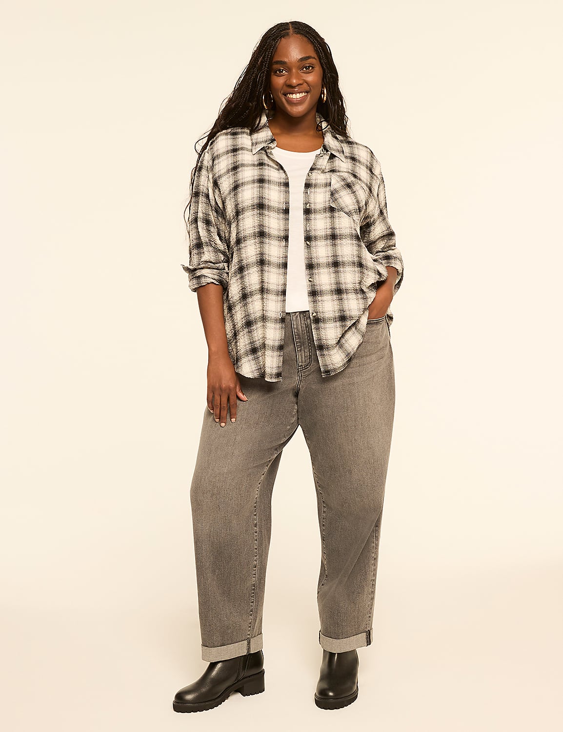 A smiling woman in a plaid shirt and gray jeans stands against a plain, light-colored background. Product Image 3