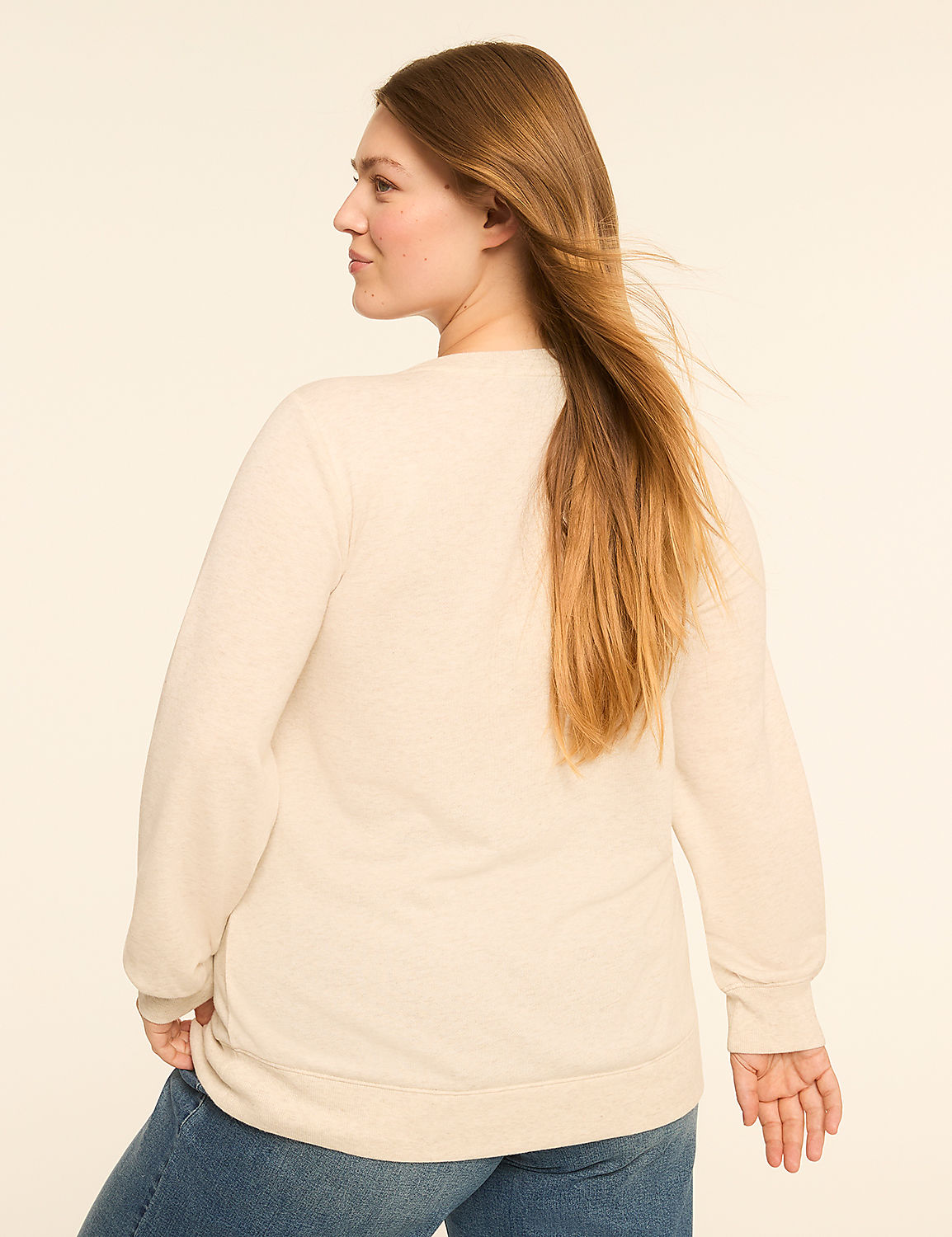 A woman with long blonde hair, wearing a cream-colored sweater and blue jeans, stands against a plain, light-colored background. Product Image 2