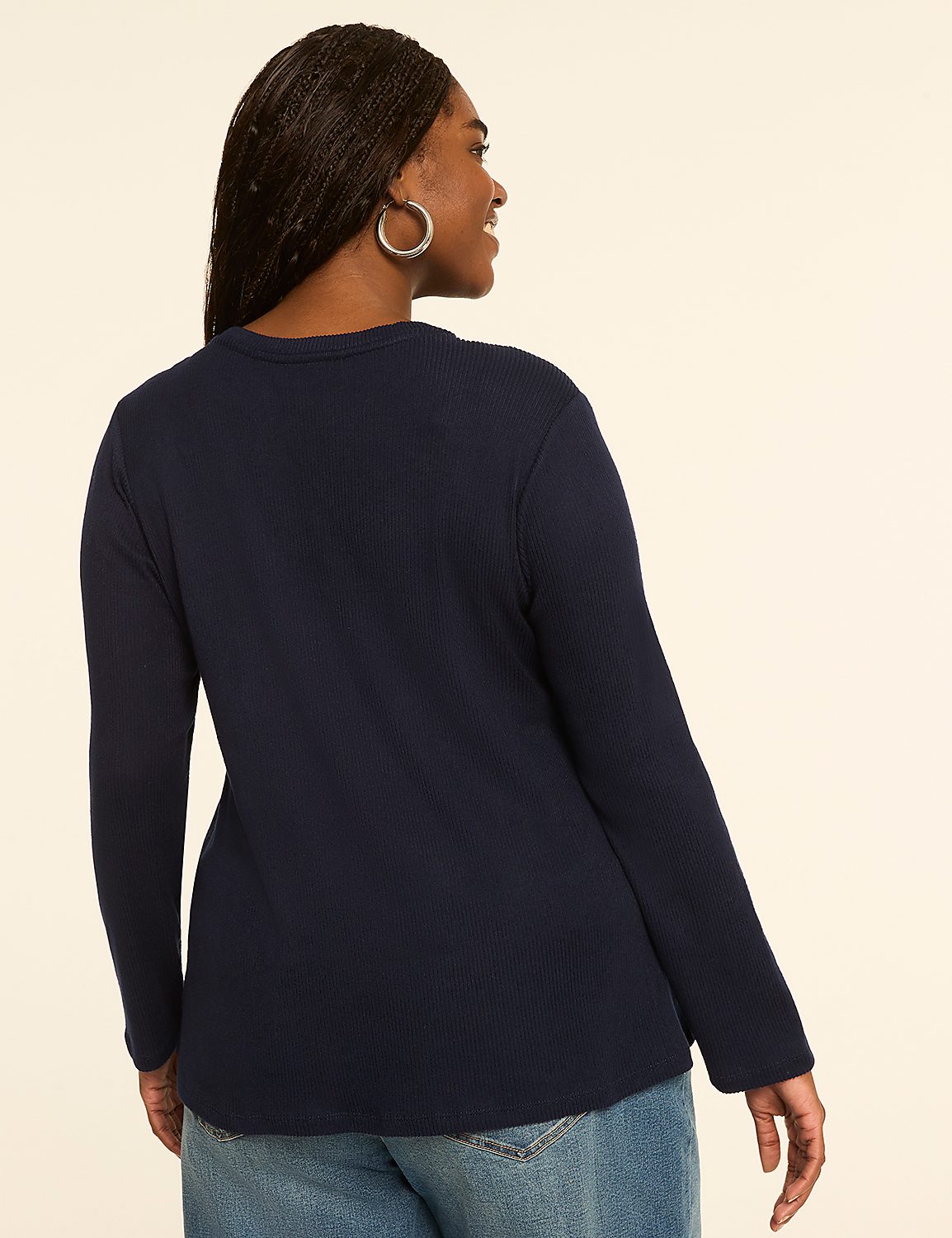 A woman in a navy long-sleeved shirt and jeans stands against a plain, light-colored background. Product Image 2
