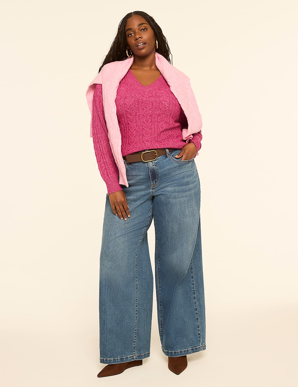 A woman in a pink sweater and wide-leg jeans stands against a plain, light-colored background. Product Image 3