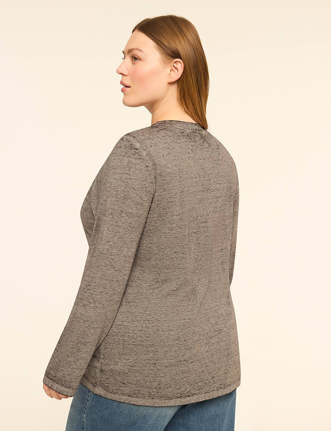 A woman in a gray long-sleeved shirt and blue jeans stands against a plain, light-colored background. Product Image 2