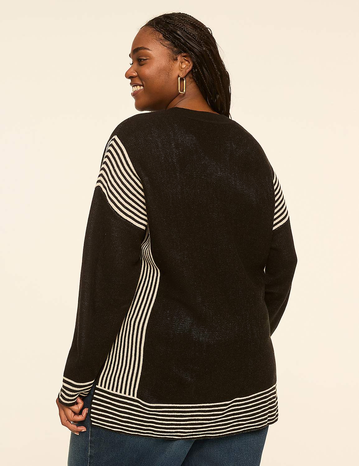 A woman in a striped sweater smiles over her shoulder against a plain, light-colored background. Product Image 2