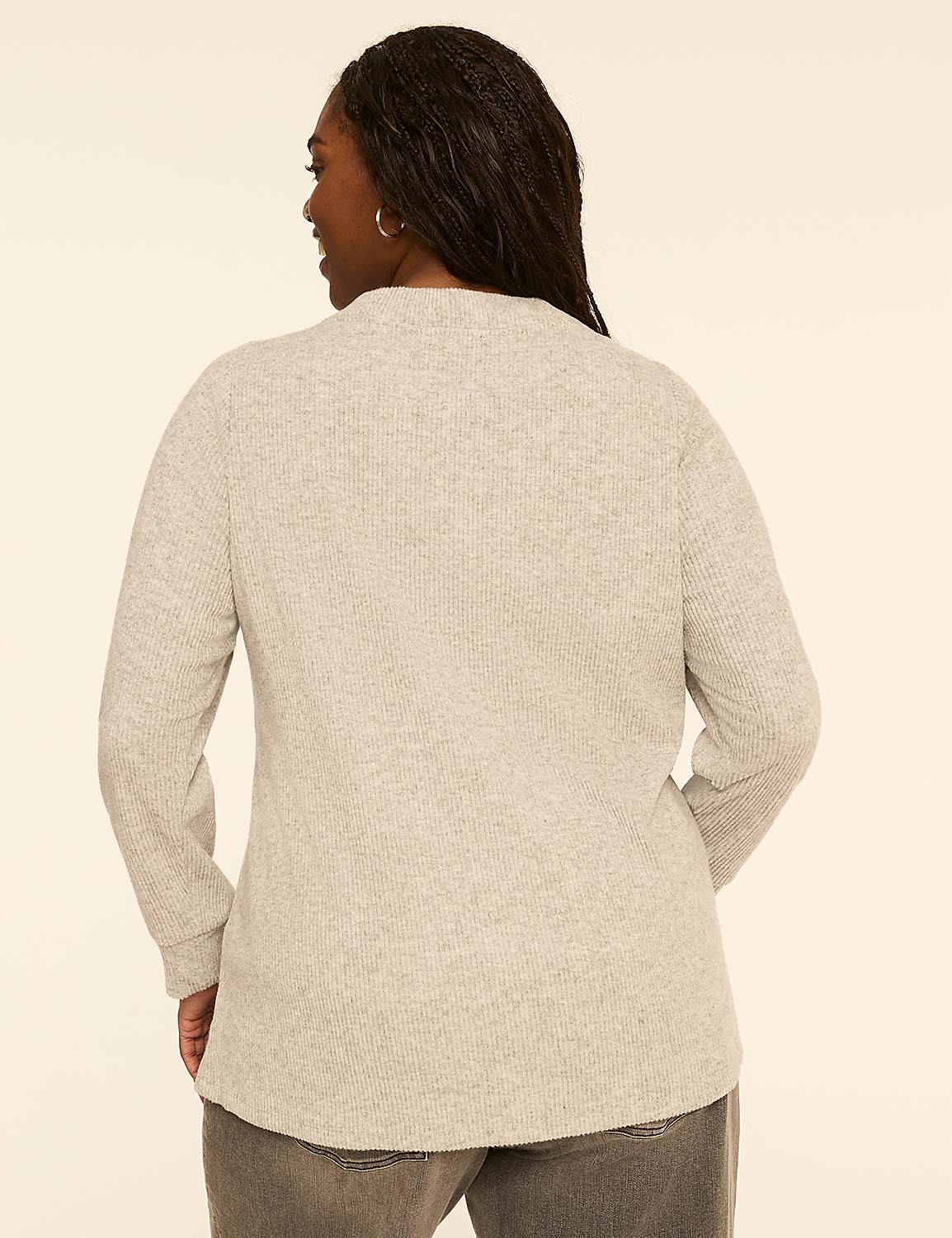 A woman in a grey sweater and jeans stands against a plain, light-colored background. Product Image 2