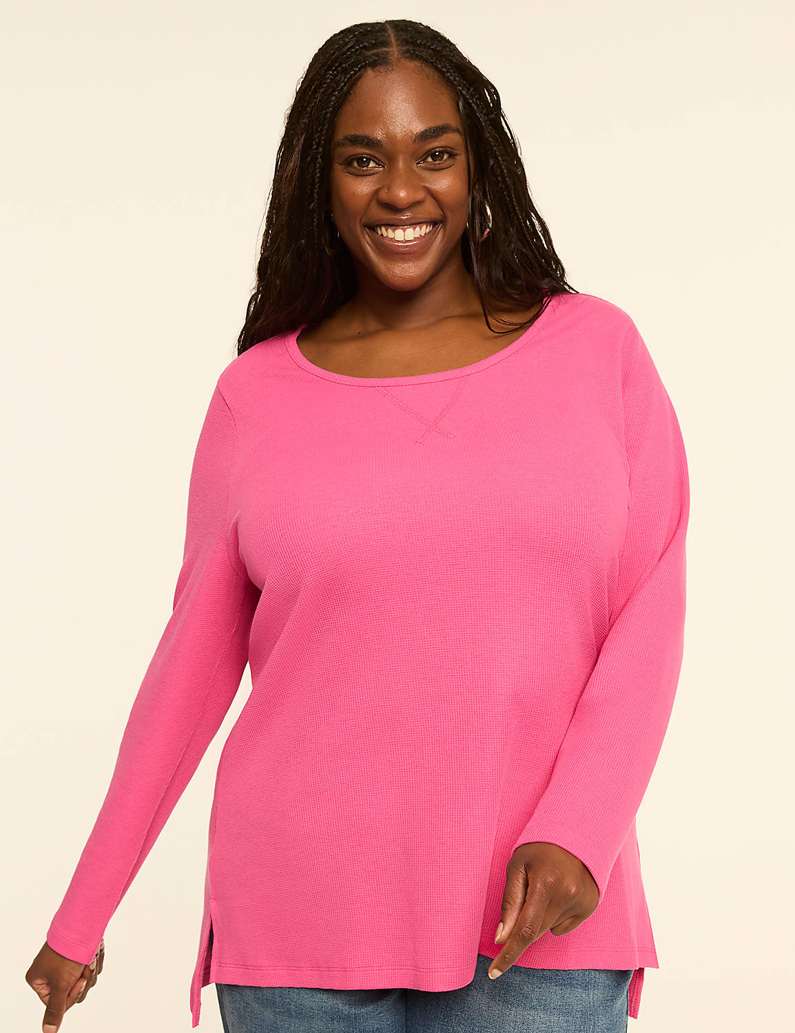 A smiling woman with braided hair wears a bright pink long-sleeved shirt against a plain, light-colored background. Product Image 1