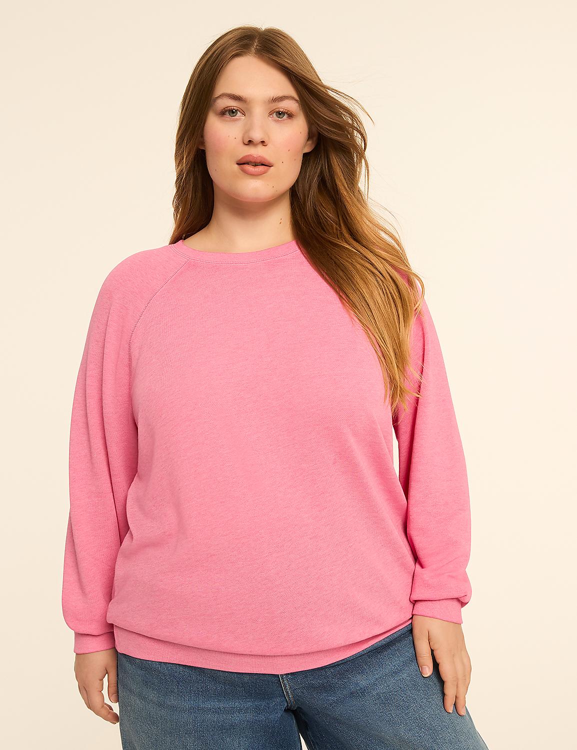 A woman with long, blonde hair and fair skin, wearing a pink sweatshirt and blue jeans, stands against a plain, light-colored background. Product Image 1
