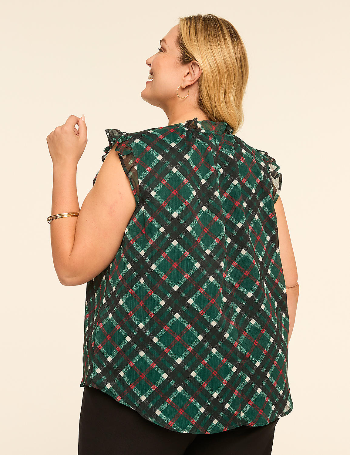 A woman in a green plaid top with ruffled sleeves is shown from the back against a plain, light-colored background. Product Image 2