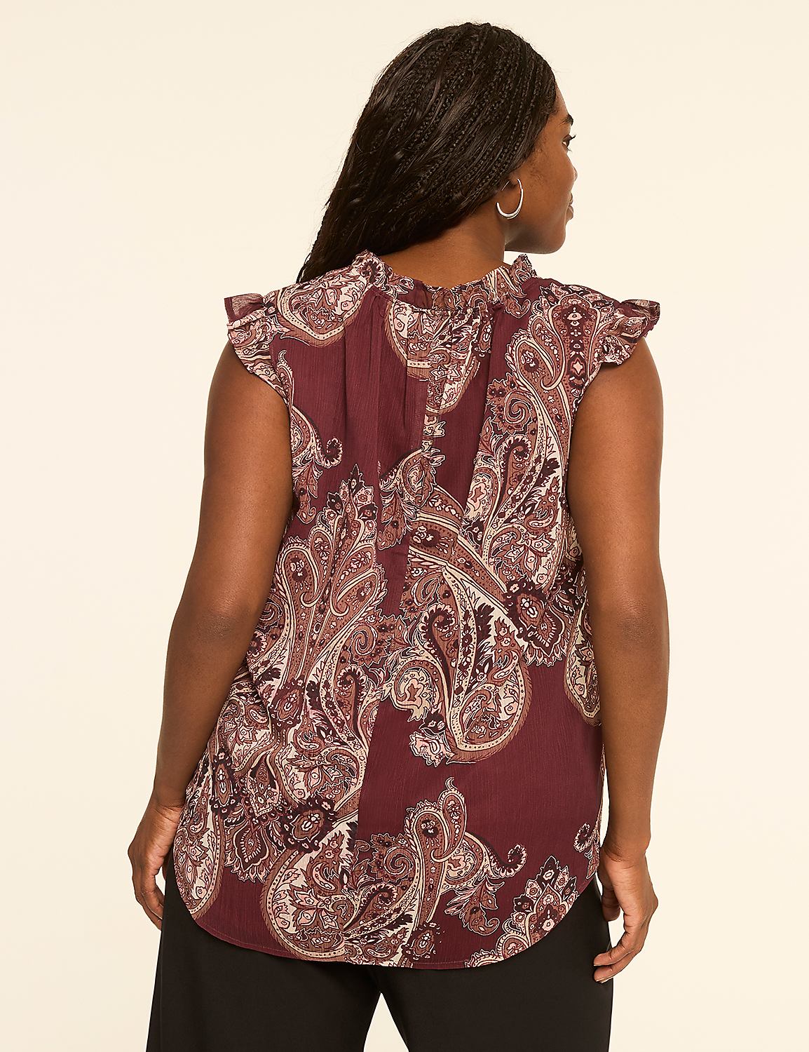 A woman in a paisley-patterned blouse stands against a plain, light-colored background. Product Image 2