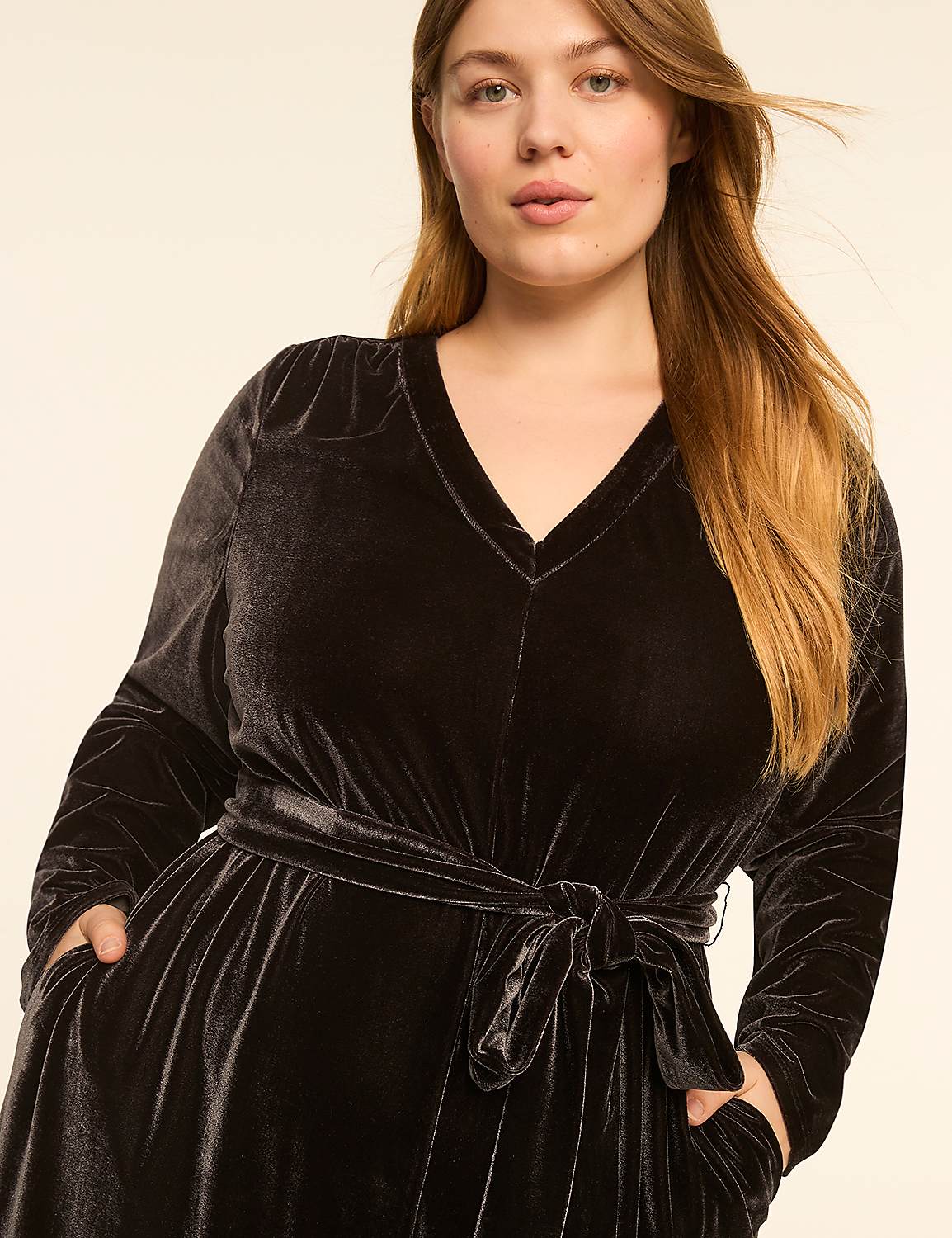 A woman in a dark velvet dress with a tie waist stands against a plain, light background. Product Image 3