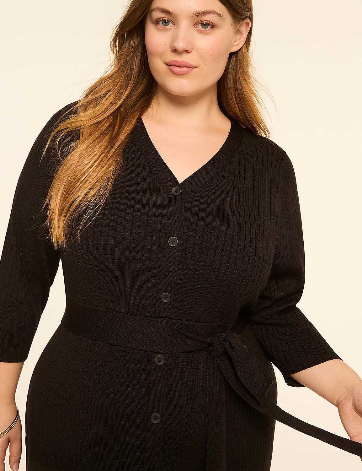 A woman in a black ribbed dress with a tie waist is shown against a plain, light background. Product Image 3