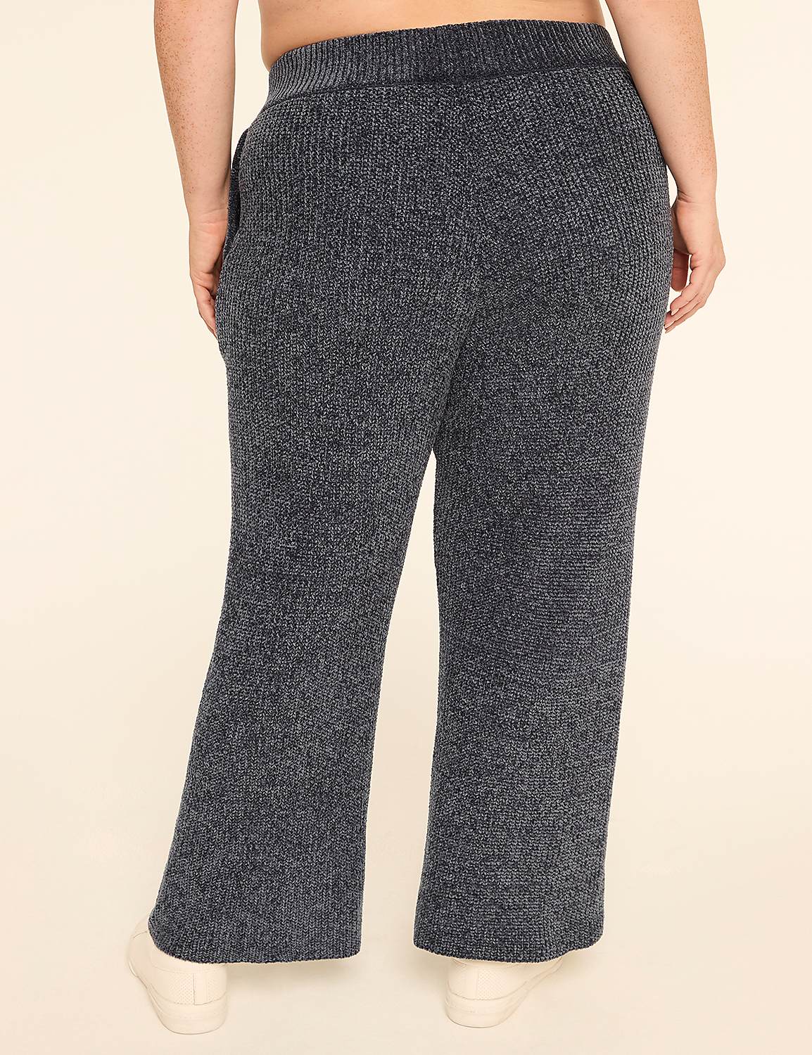 A person wearing fuzzy dark gray lounge pants stands against a plain cream background. Product Image 2