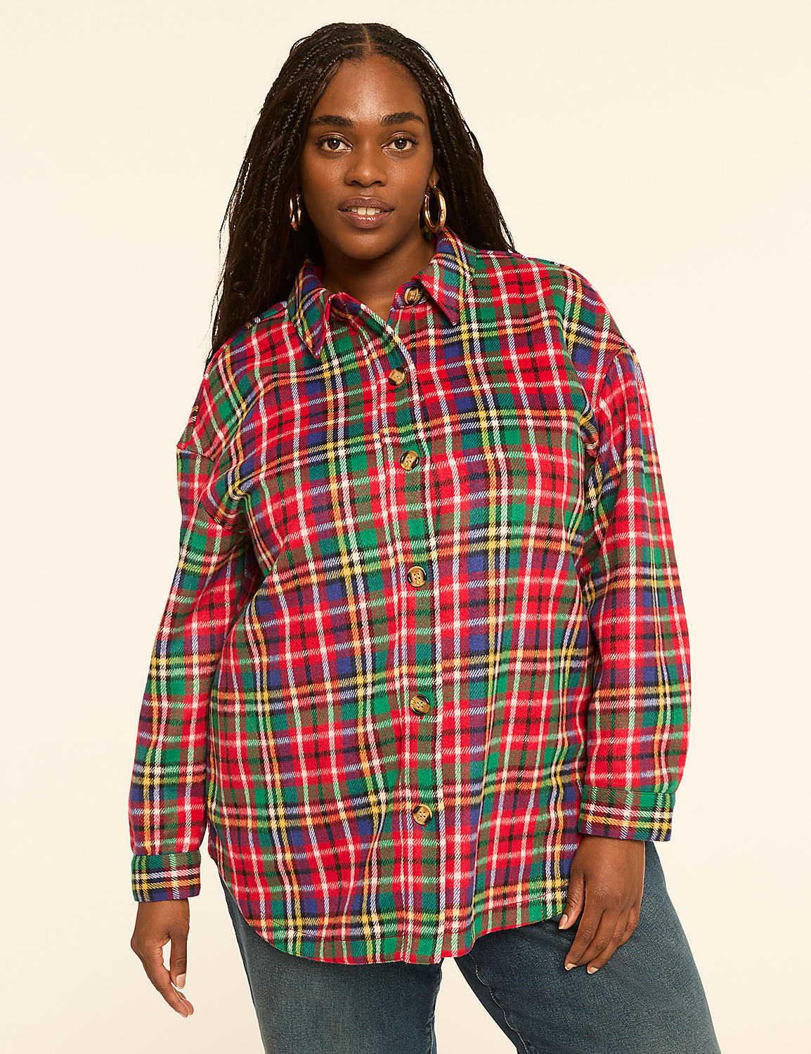 A woman with braided hair and hoop earrings poses in a red, green, and yellow plaid shirt against a plain, light-colored background. Product Image 1