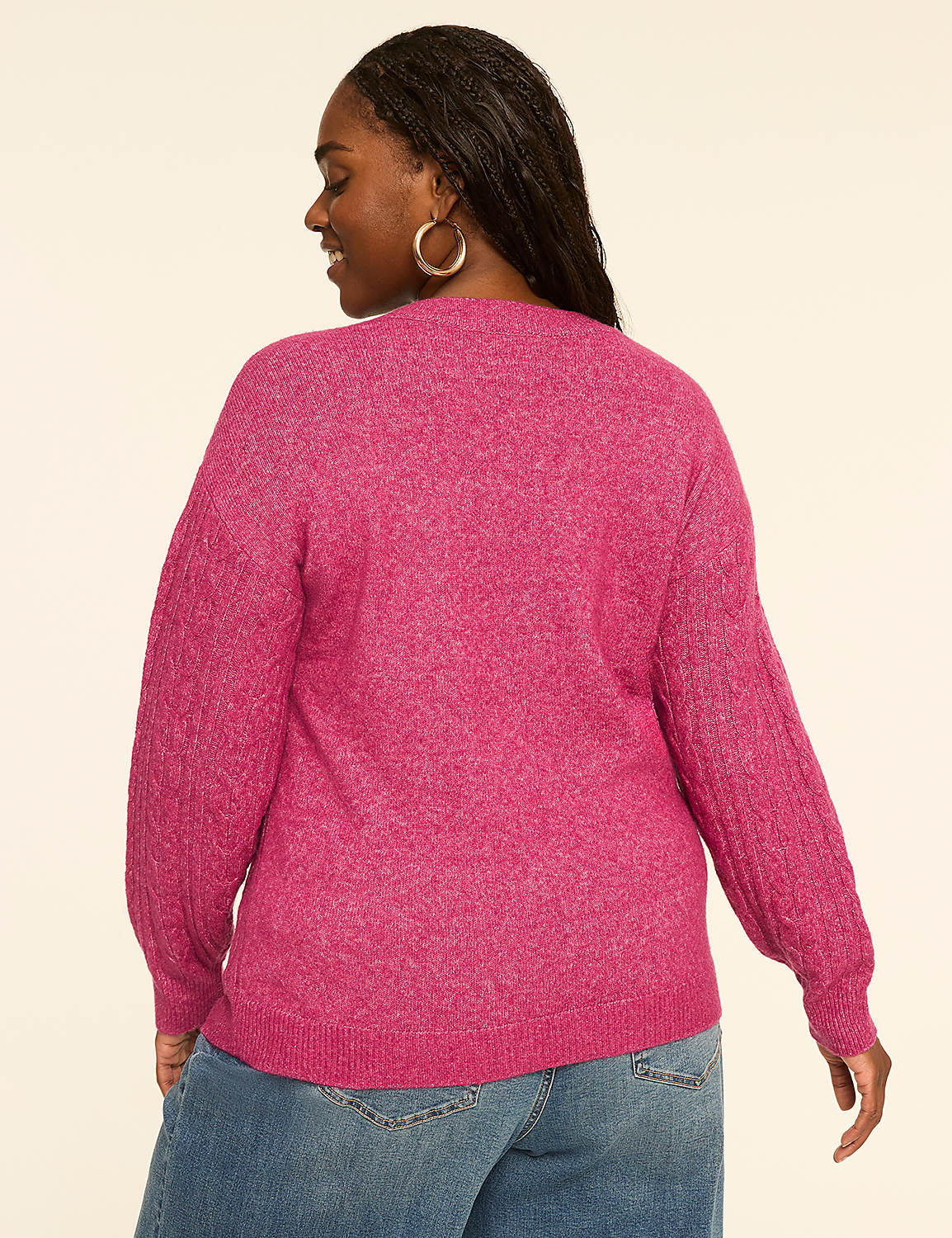 A woman in a pink sweater and jeans stands against a plain, light-colored background. Product Image 2