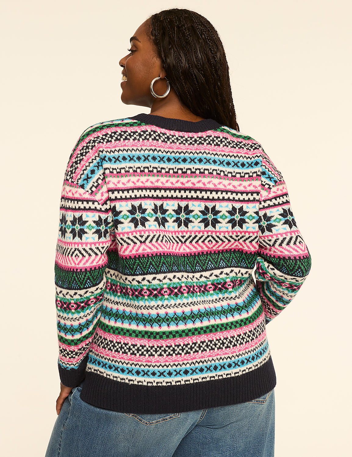 A woman in a colorful, patterned sweater stands against a plain, light-colored background. Product Image 2