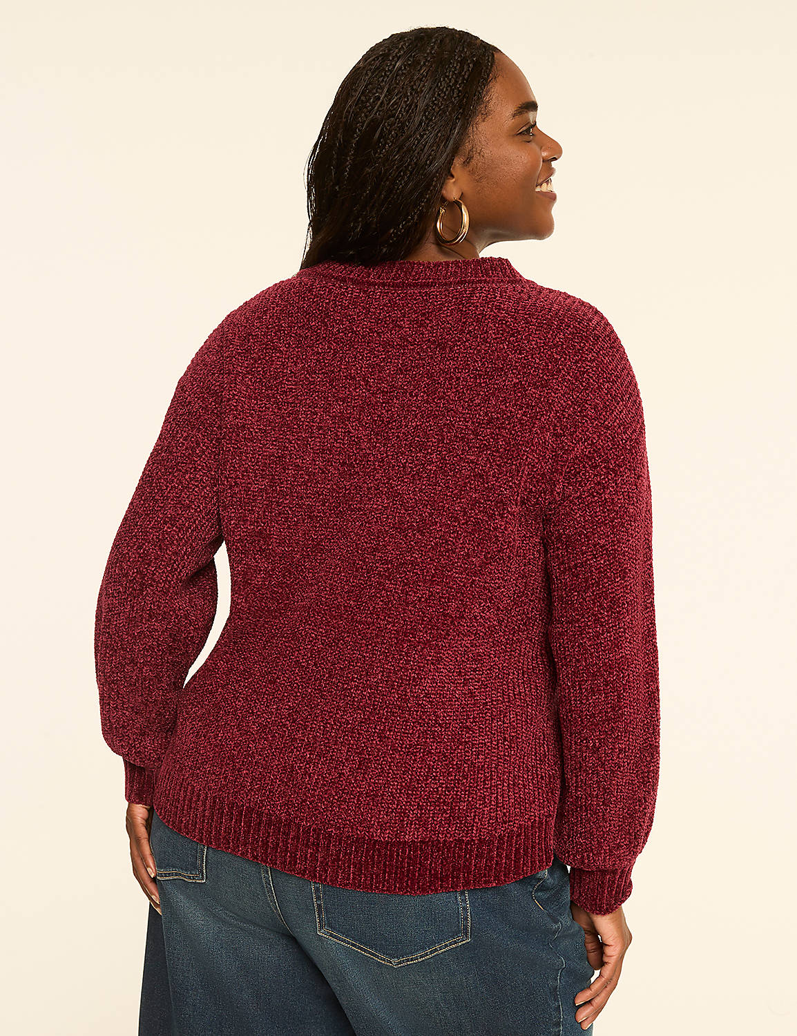 A woman in a burgundy chenille sweater and blue jeans stands against a plain, light-colored background. Product Image 2