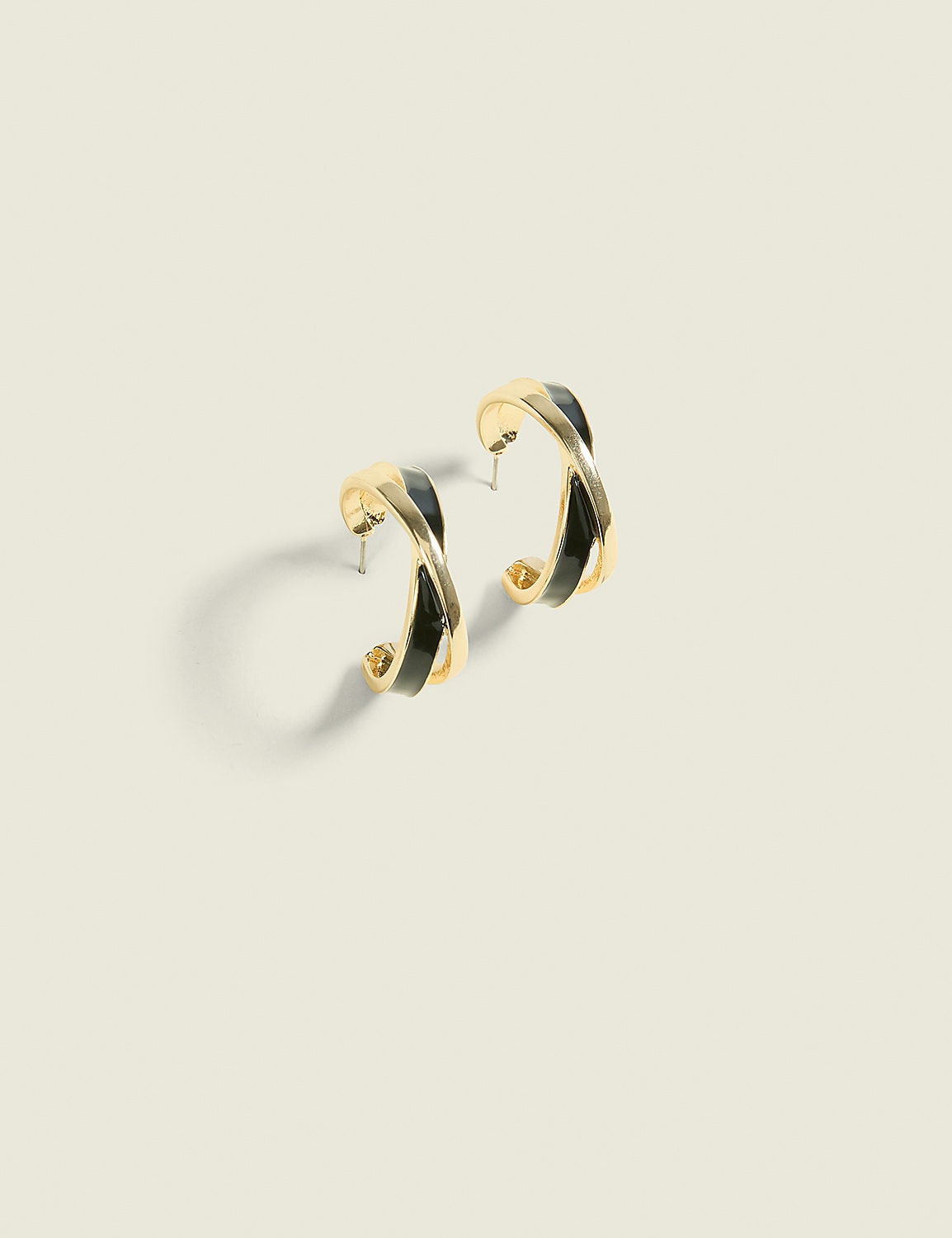 A pair of gold hoop earrings with black accents rests on a plain, light-colored background. Product Image 1