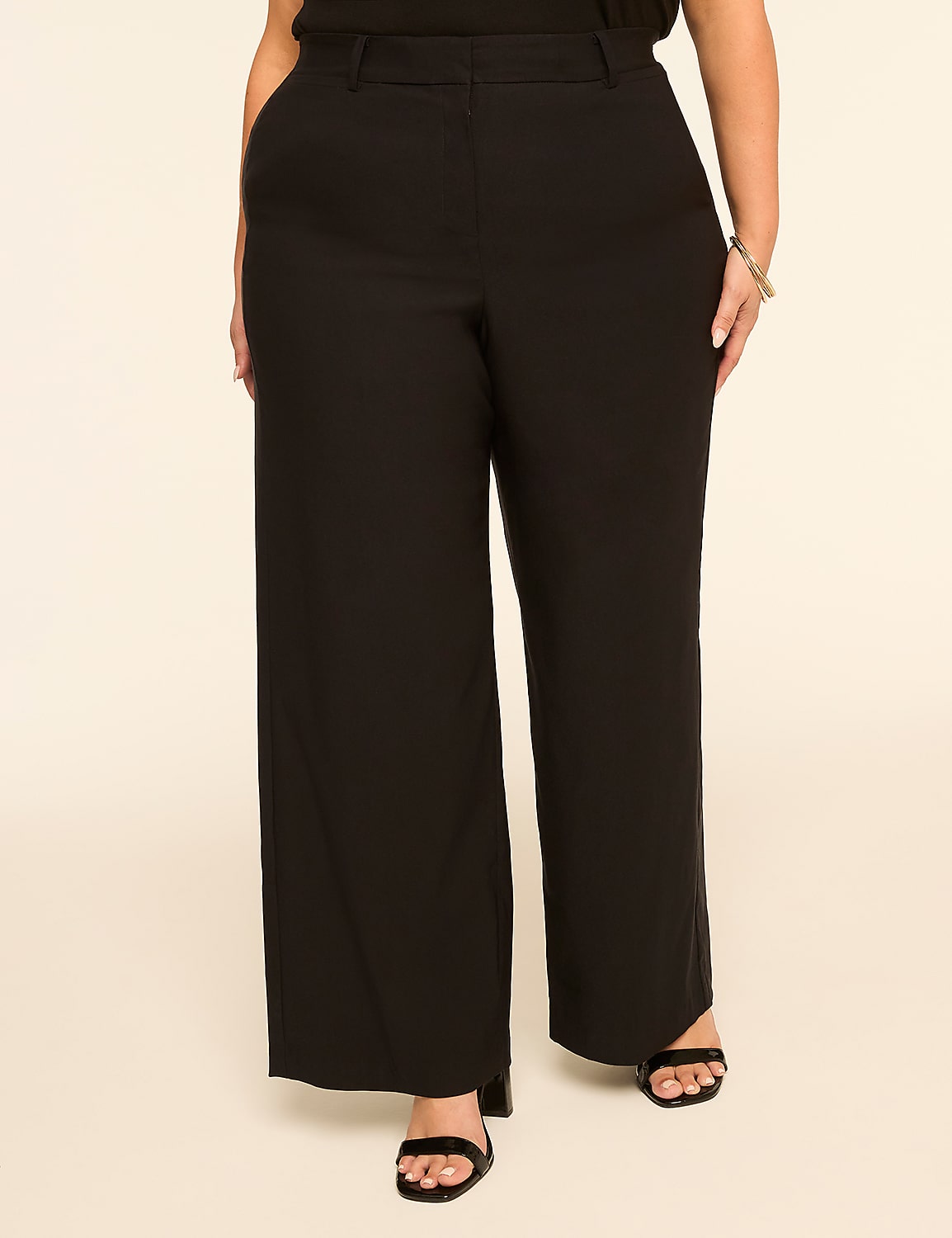 A person wearing black wide-leg pants and black sandals stands against a plain, light-colored background. Product Image 1