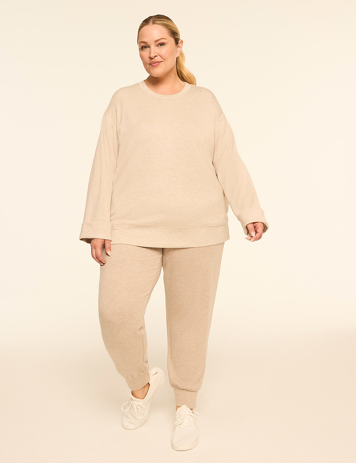A woman in a beige loungewear set stands against a plain, light-colored background. Product Image 3