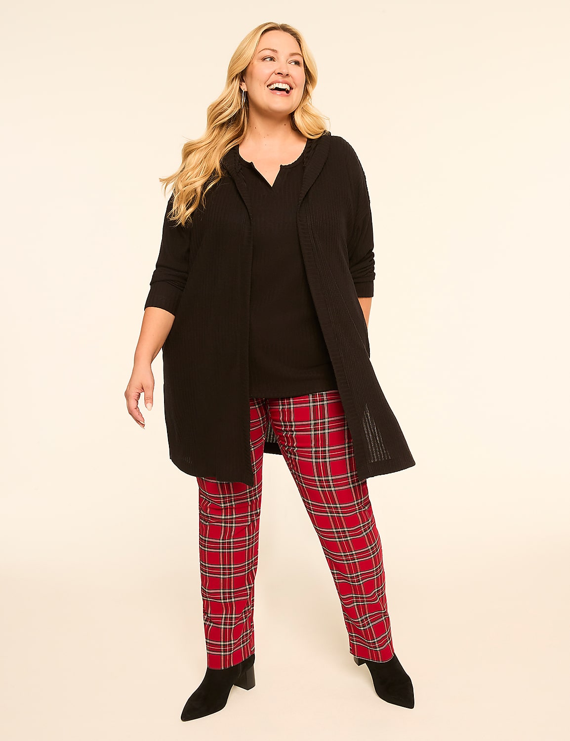 A smiling woman in a black top, open cardigan, and red plaid pants stands against a plain, light-colored background. Product Image 3