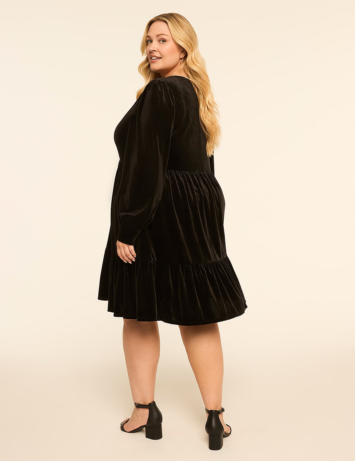 A blonde woman in a black velvet dress stands against a plain, light-colored background. Product Image 2