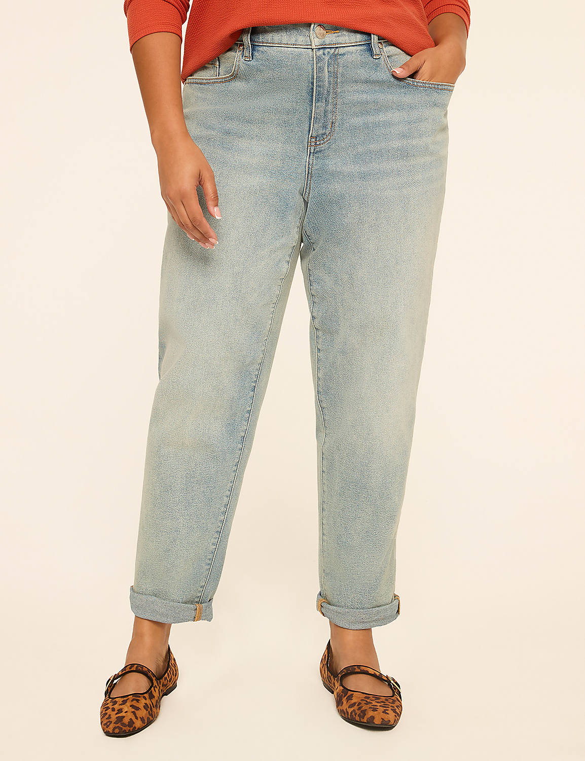 A person wearing light-wash jeans and leopard print flats stands against a plain, light-colored background. Product Image 1