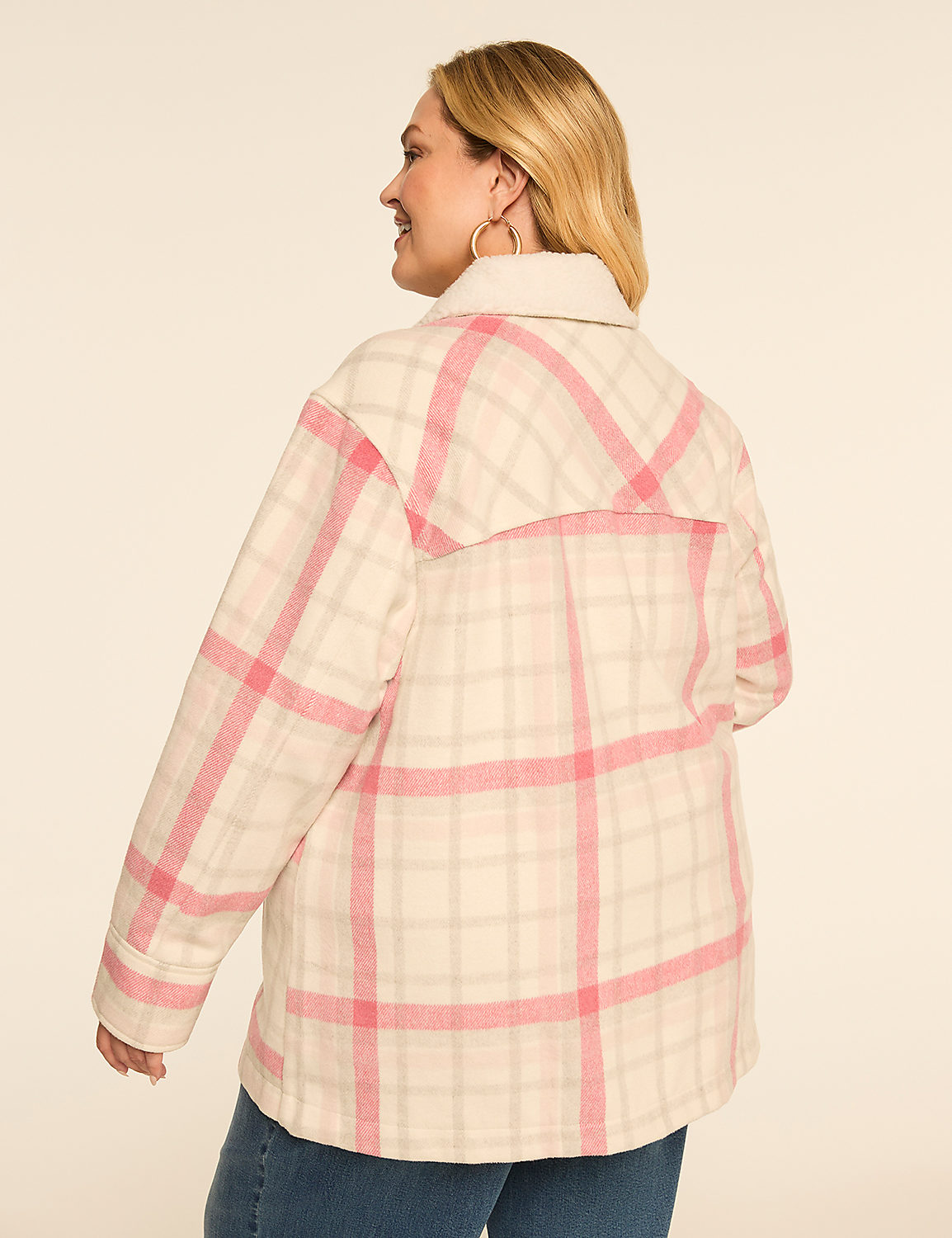 A woman in a cream and pink plaid jacket stands against a plain, light-colored background. Product Image 2