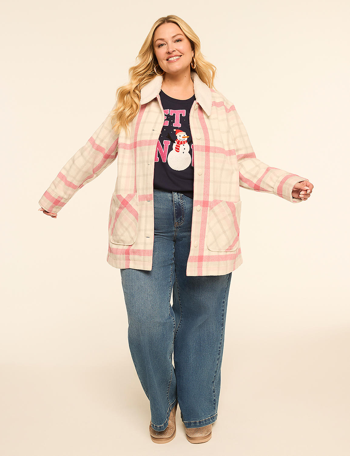 A smiling woman in a plaid jacket and jeans stands against a plain, light-colored background. Product Image 3