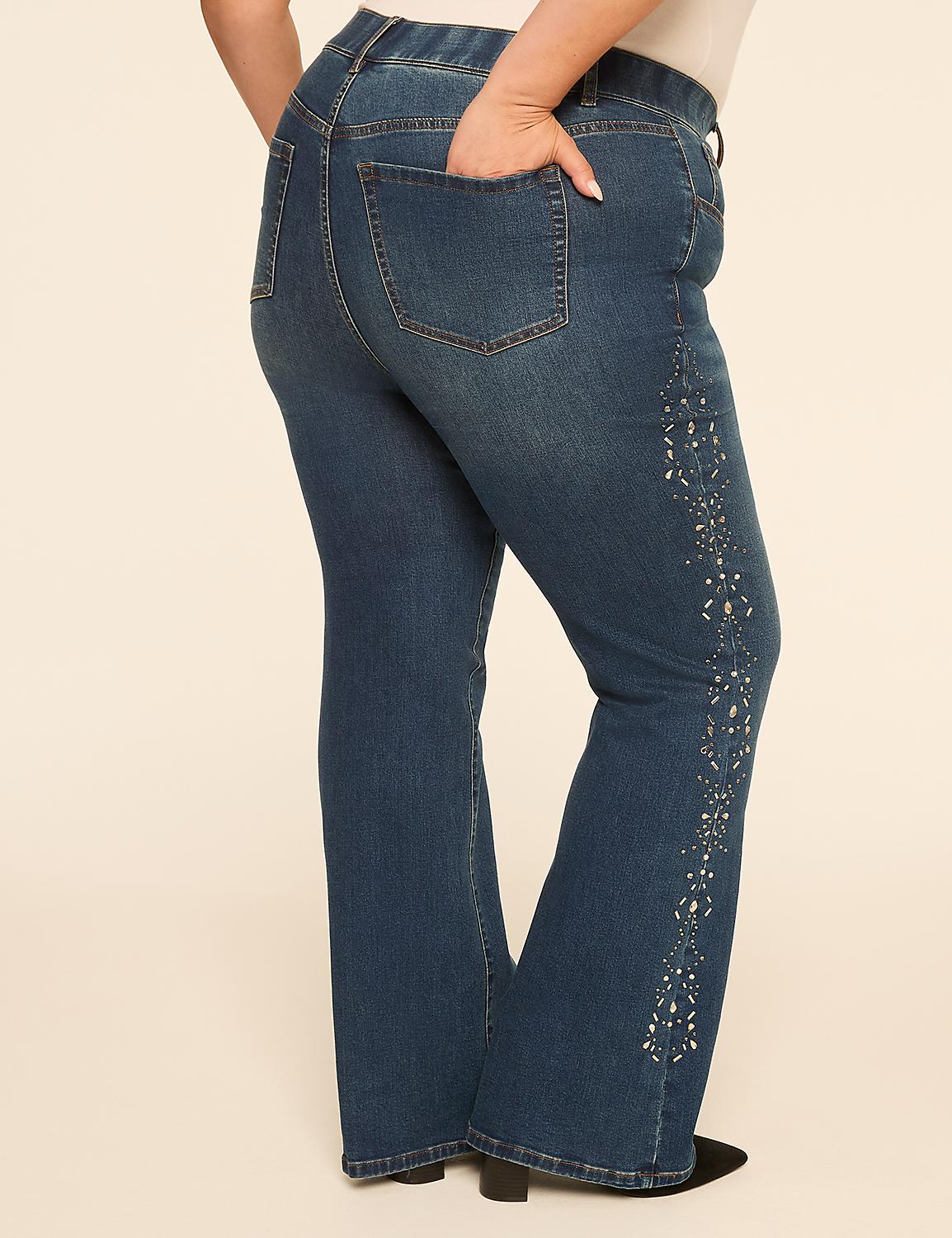 A person's lower body is shown from the side, wearing flared blue jeans with decorative embellishments on the side, against a plain, light-colored background. Product Image 2