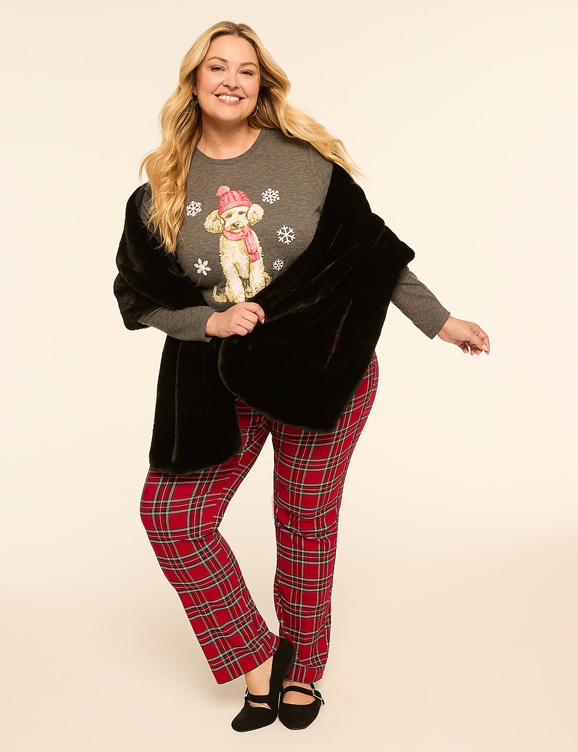 A smiling woman in a grey sweater with a poodle graphic and red plaid pants is draped in a black faux fur stole against a plain, light background. Product Image 3