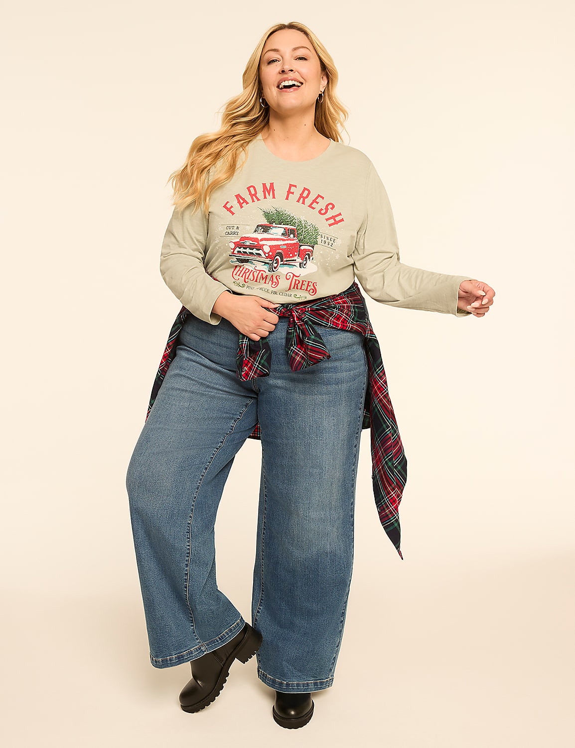 A smiling woman in a festive long-sleeved shirt and wide-leg jeans poses against a plain, light-colored background. Product Image 3