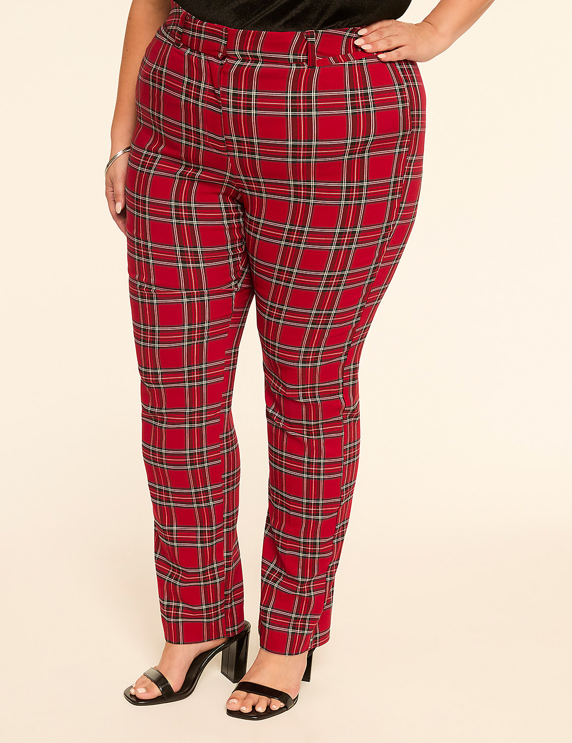 A person stands in front of a plain, light-colored background, wearing red plaid pants and black heels. Product Image 1