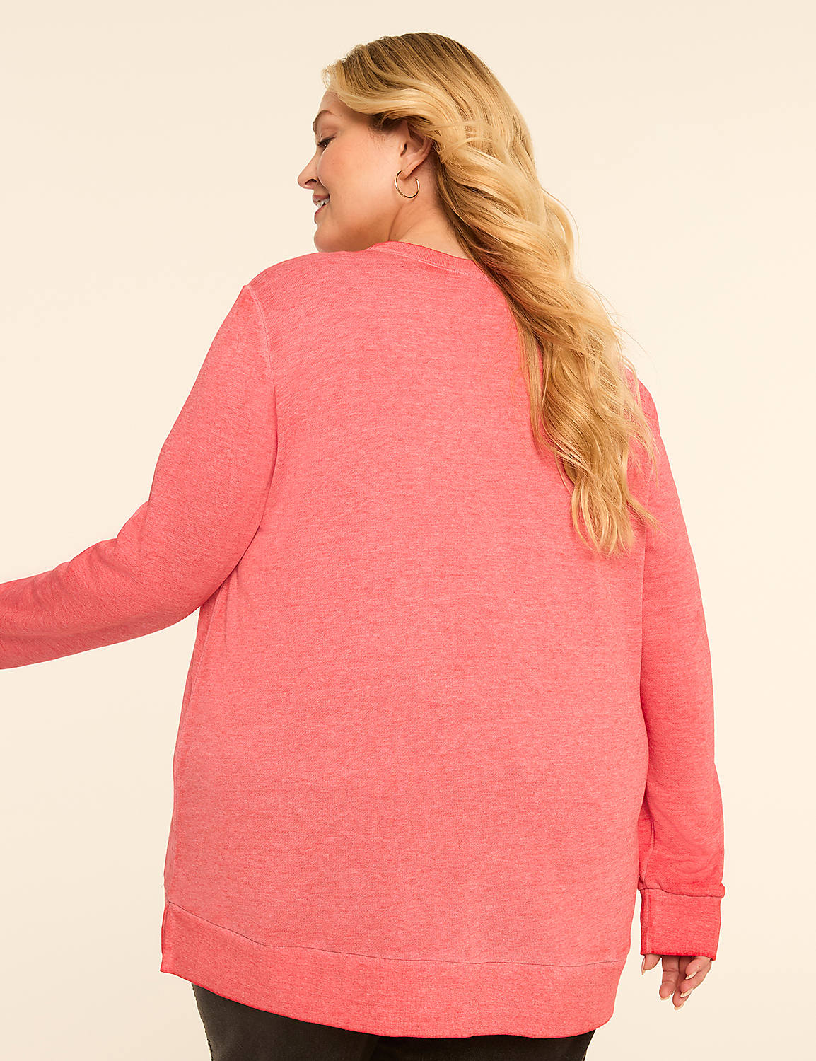 A woman in a coral sweatshirt stands against a plain, light-colored background. Product Image 2
