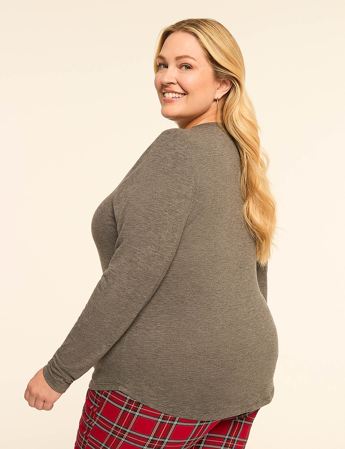 A smiling woman in a gray waffle-knit top and red plaid pants poses against a plain cream background. Product Image 2
