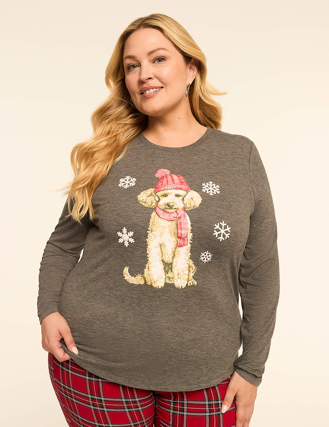 A woman in a grey long-sleeved shirt with a dog graphic and red plaid pants stands against a plain, light background. Product Image 1