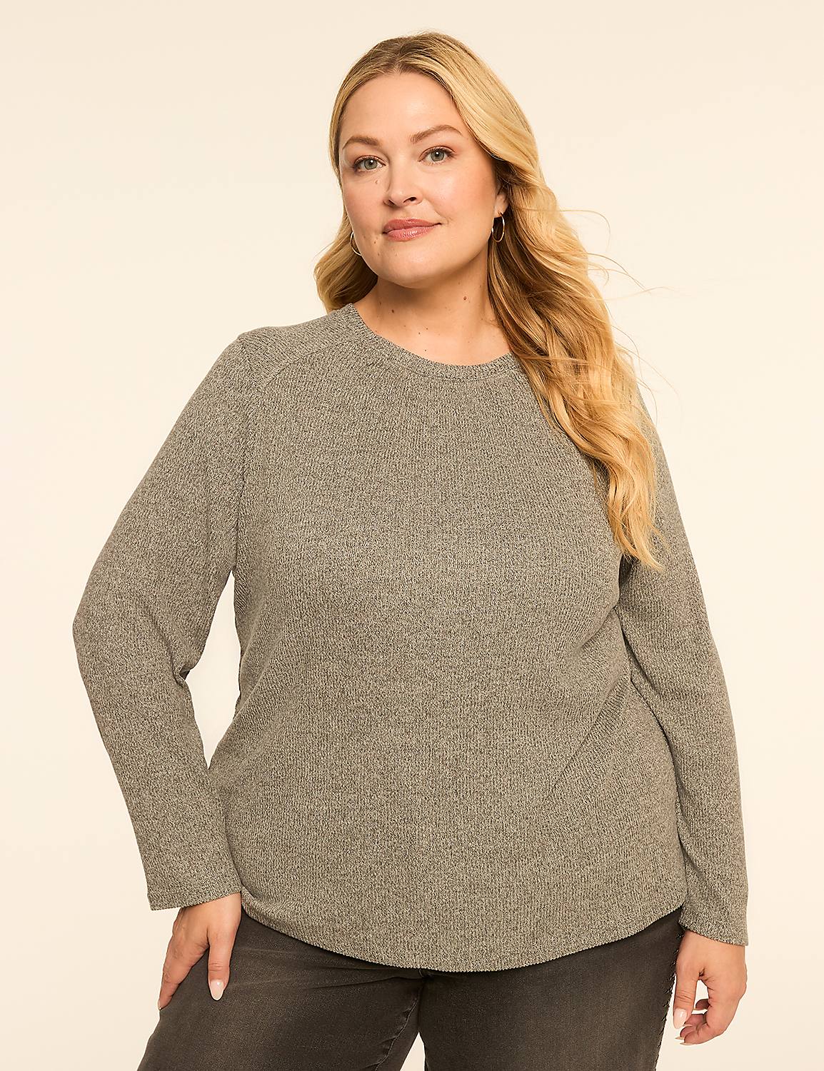 A woman with blonde hair and a gray sweater stands against a plain, light-colored background. Product Image 1