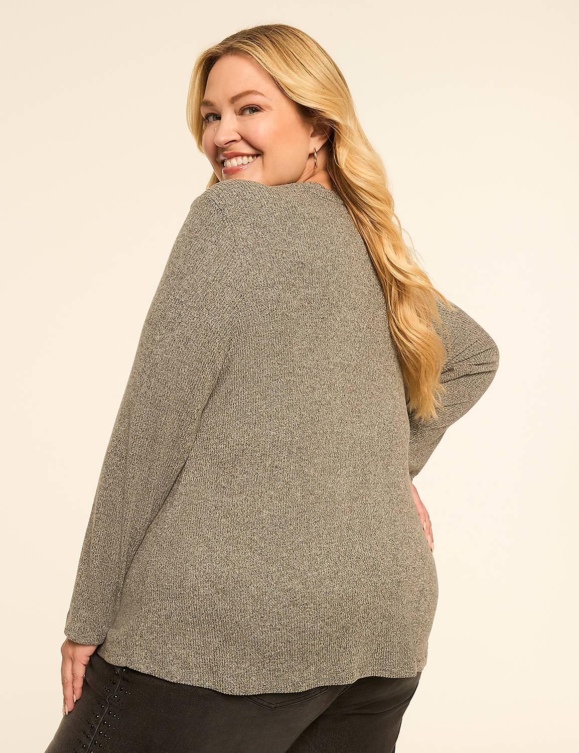 A smiling woman in a gray sweater poses against a plain, light-colored background. Product Image 2