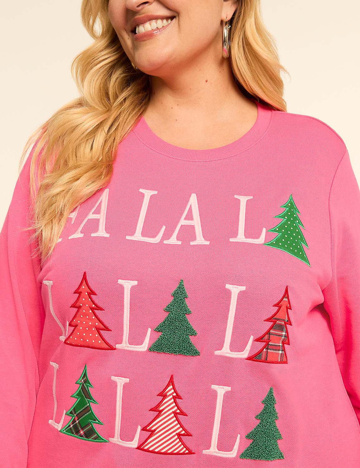 A woman in a pink sweatshirt with "FA LA LA" and Christmas trees smiles against a plain background. Product Image 4
