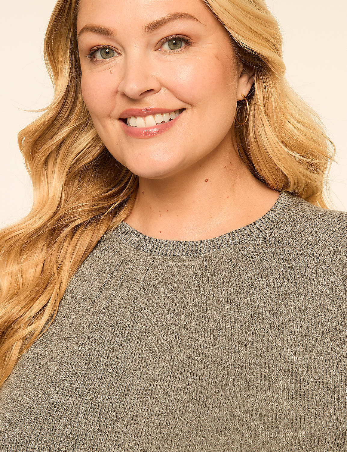 A smiling woman with blonde hair and a gray sweater is in the foreground, with a plain, light-colored background. Product Image 4