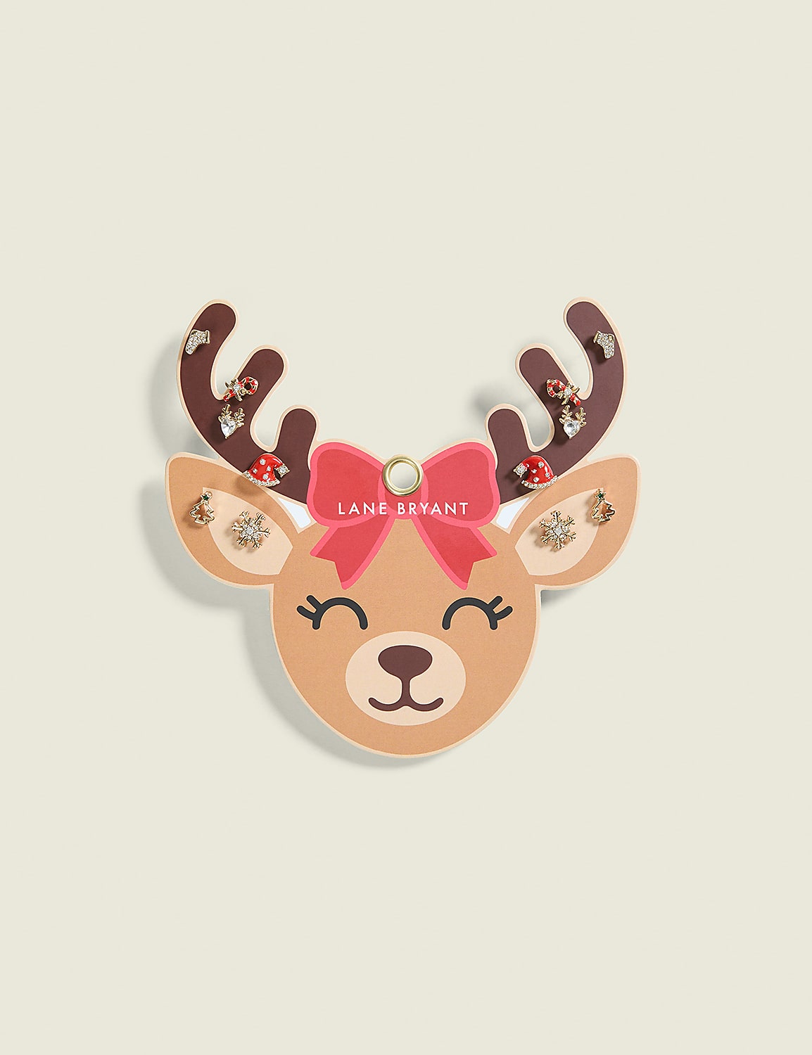 A festive reindeer earring display with a pink bow and jeweled antlers is set against a pale, textured background. Product Image 1