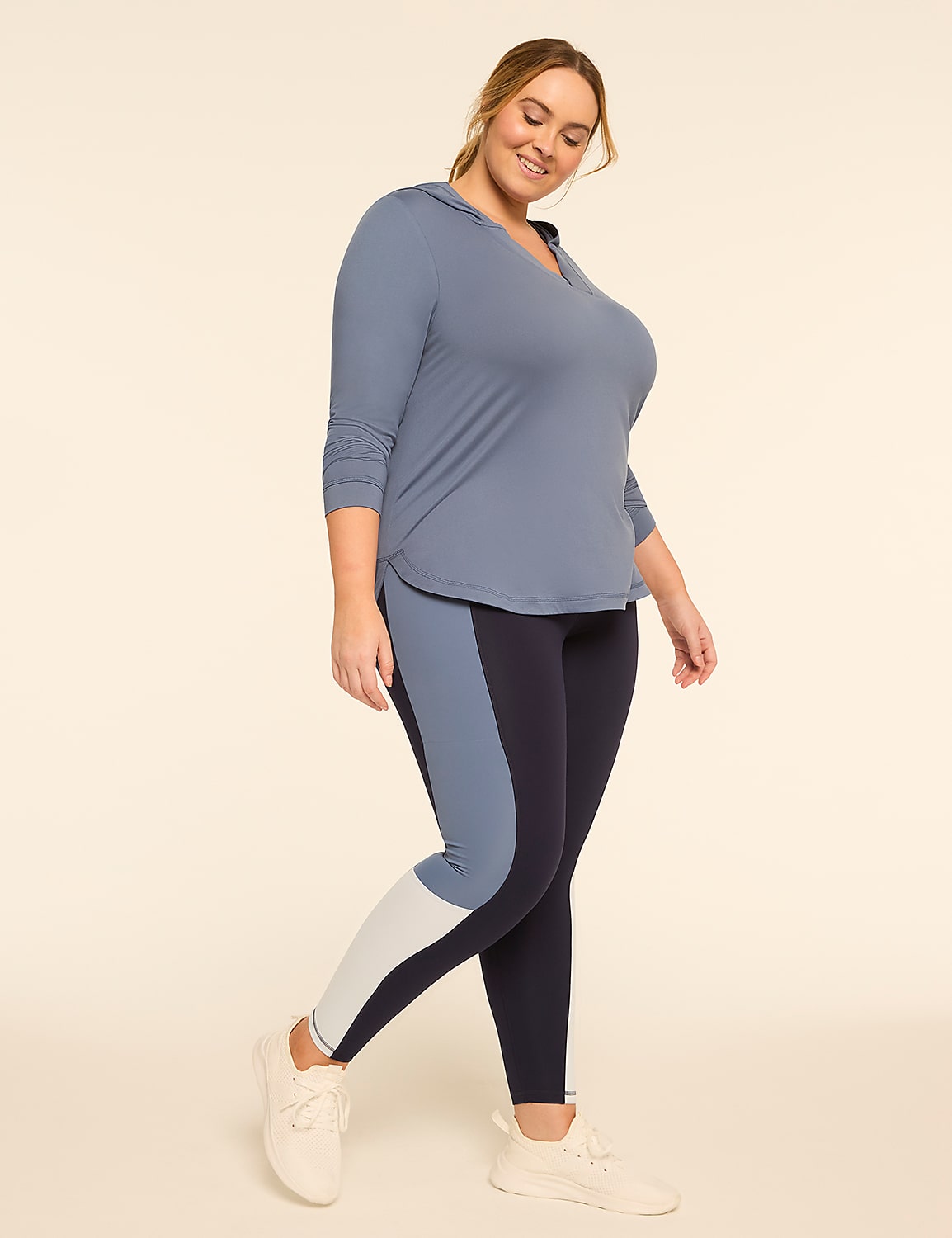 A plus-size woman in a blue hooded top and color-blocked leggings poses against a plain, light-colored background. Product Image 3