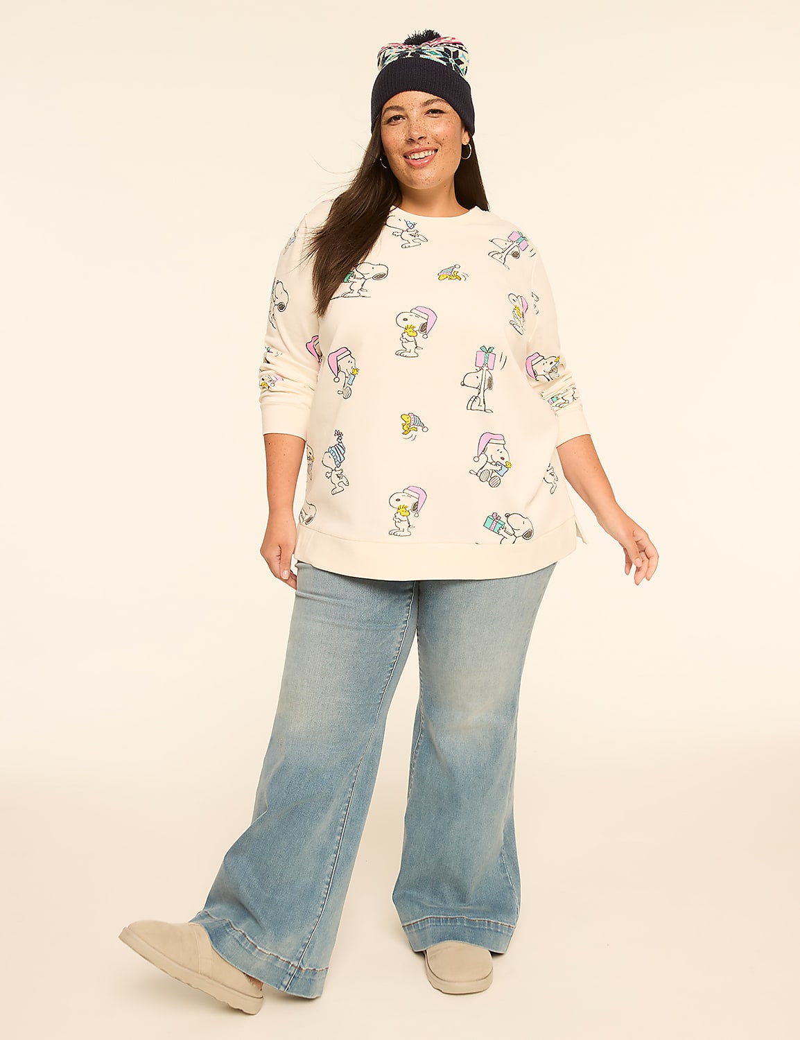 A woman in a Snoopy-print sweatshirt and wide-leg jeans poses against a plain, light-colored background. Product Image 3
